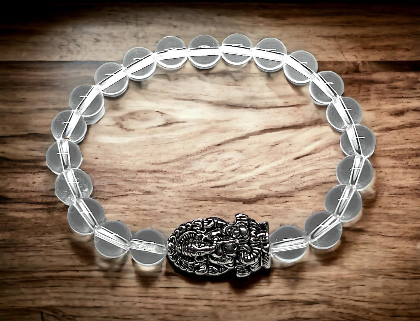 8mm Clear Crystal Quartz beaded stretch bracelet with a silver intricate Ganesha charm