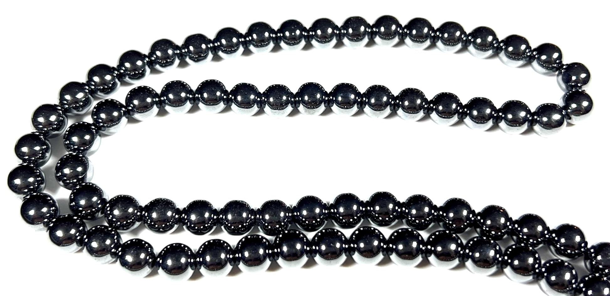 FEROX Collection Hematite Mala Necklace flat lay display showcasing 108 Hand-Knotted 8mm Natural Hematite Beads, metallic silver-black finish, Root Chakra grounding properties, magnetic healing energy, spiritual protection benefits, meditation jewelry craftsmanship, Handmade USA by AYK