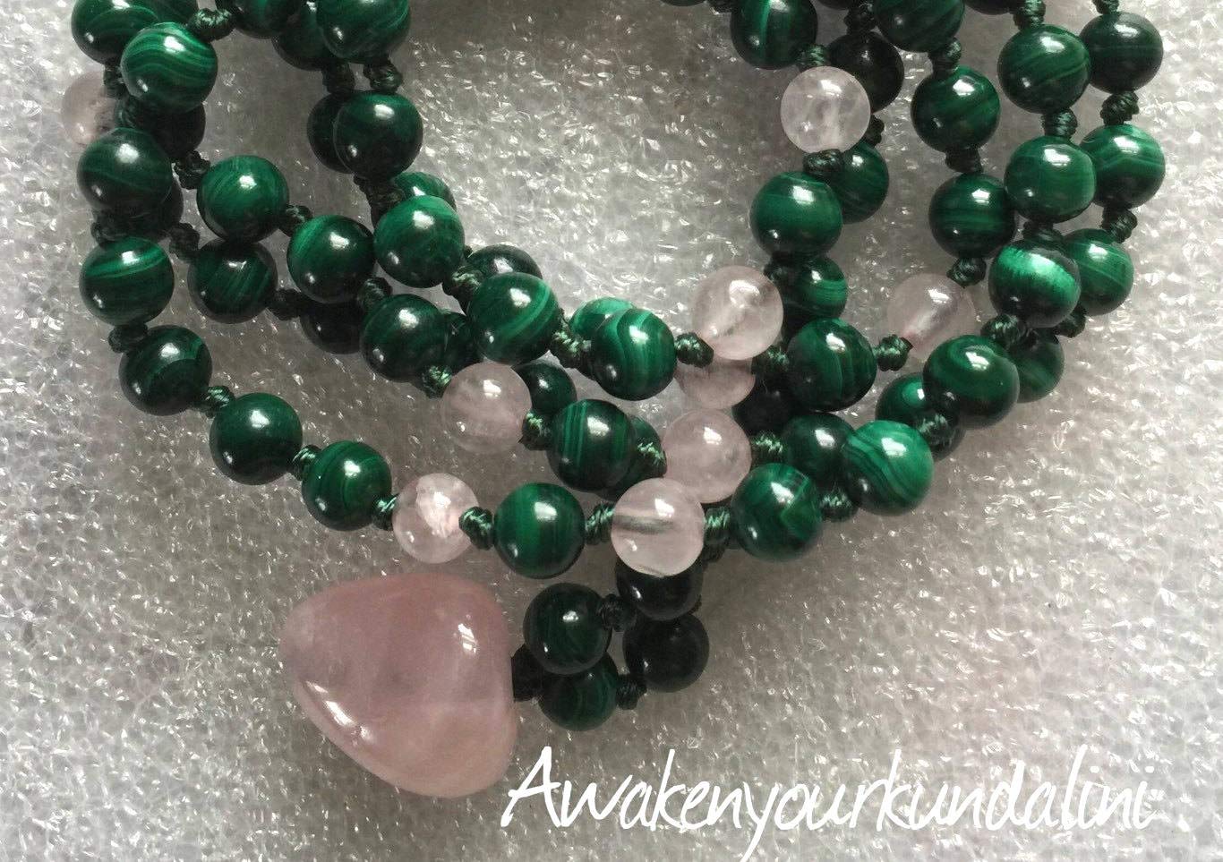 Close-up view of Malachite and Rose Quartz mala beads showing natural stone patterns and hand-knotted construction