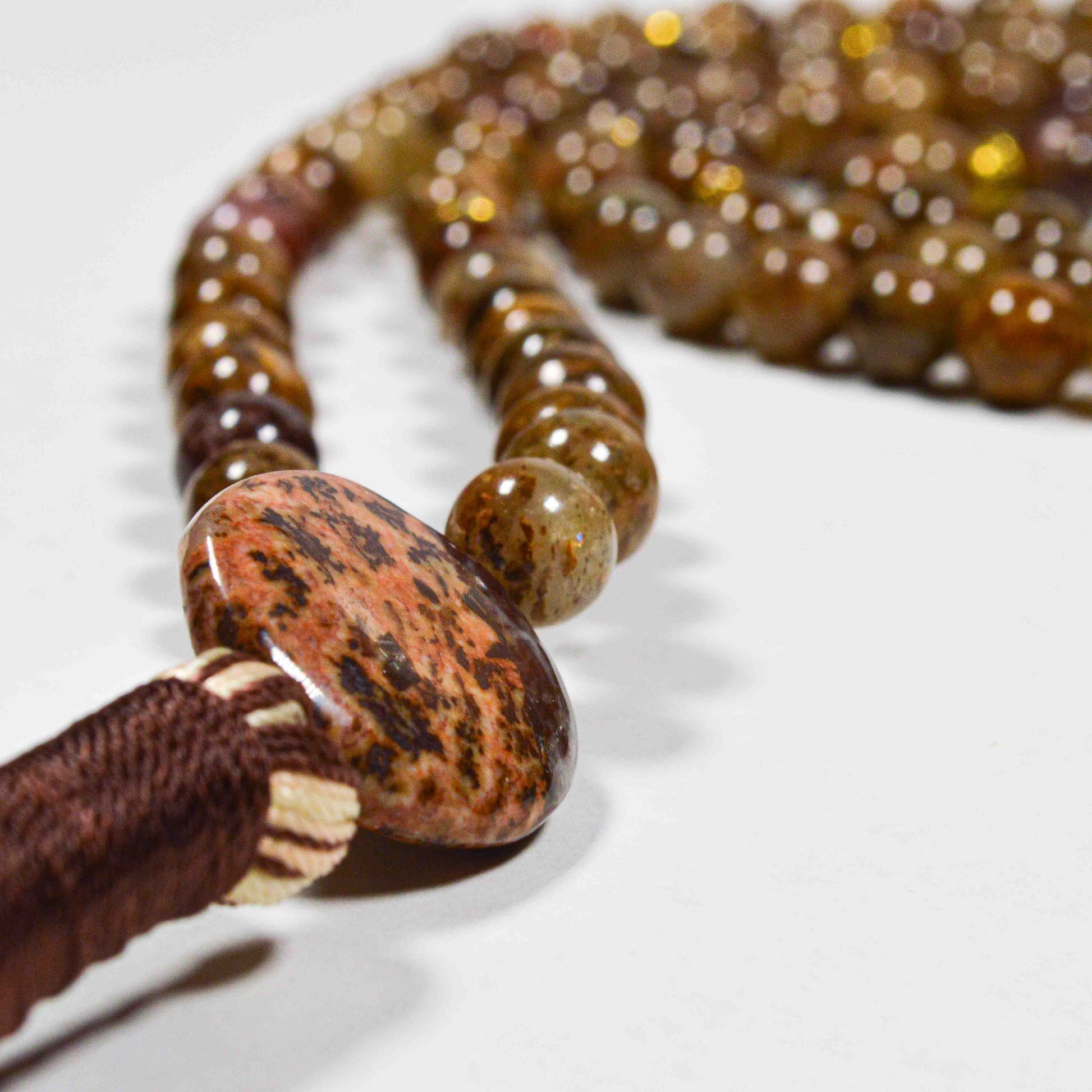 Detailed view of hand-knotted Gold Leaf Jasper beads for grounding and spiritual balance
