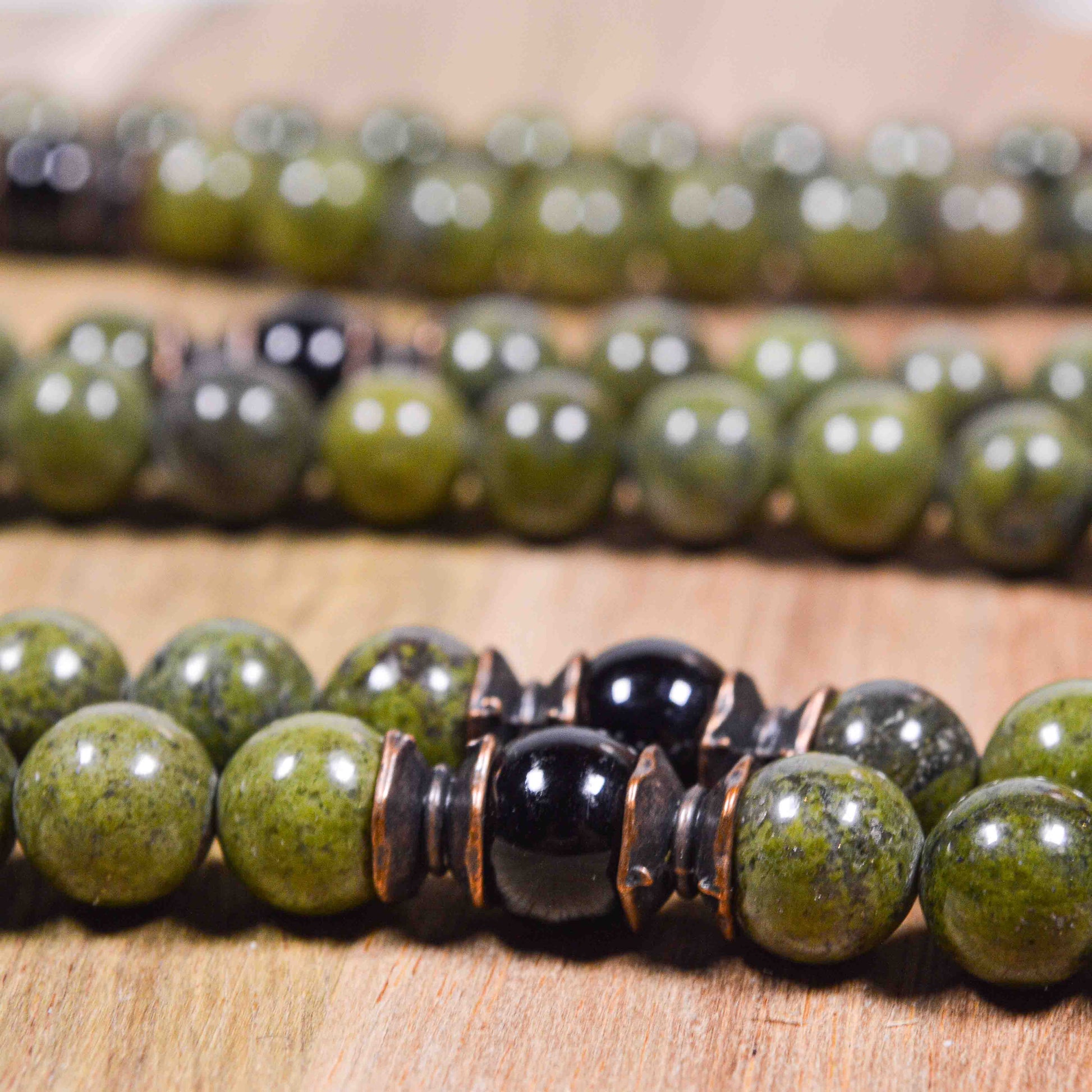 Artistic composition of Green African Jade & Tourmaline mala necklace highlighting the spiritual and protective qualities of the stones