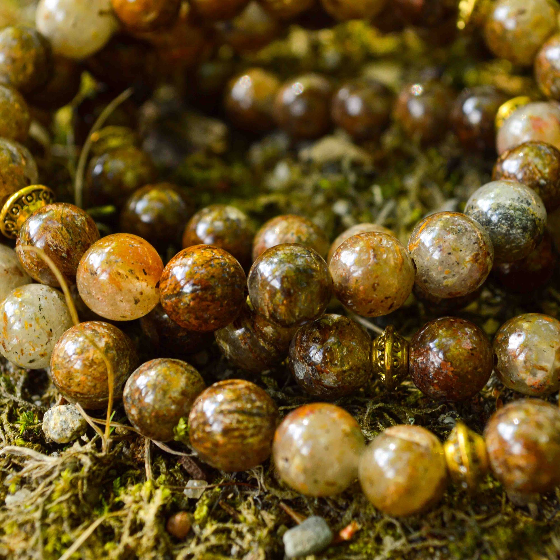 Close-up view of Gold Leaf Jasper mala beads showing natural golden streaks and earthy brown tones