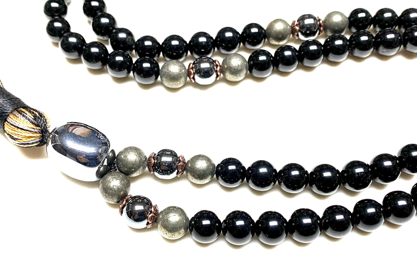 Close-up view of 8mm Tourmaline Terahertz Pyrite Hematite beads showing natural stone patterns