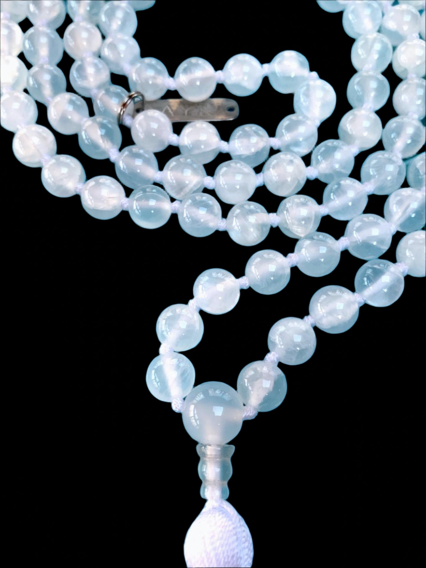 Hand knotted selentte mala necklace with 8mm bead size and 108 beads strung in white nylon thread and white tassel