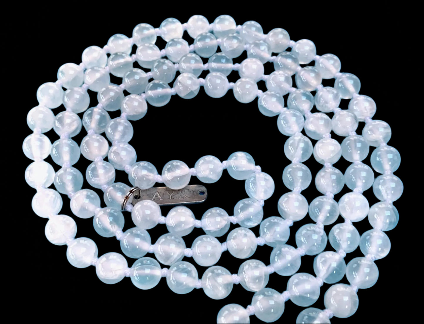 Hand knotted selentte mala necklace with 8mm bead size and 108 beads strung in white nylon thread and white tassel