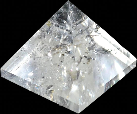 Crystal quartz pyramid on a black background