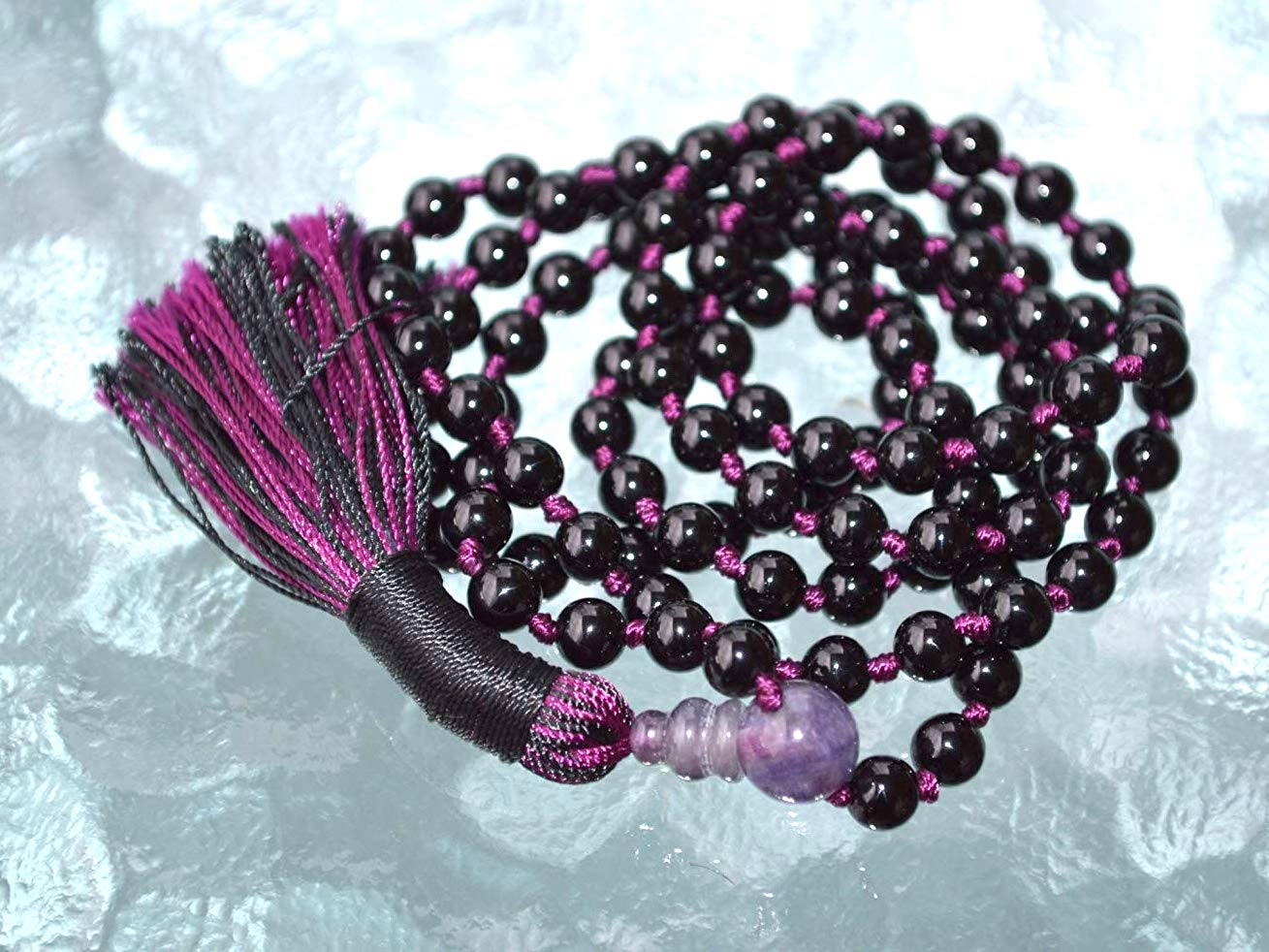 Detail shot of Black Tourmaline beads with different colored thread options for personalization