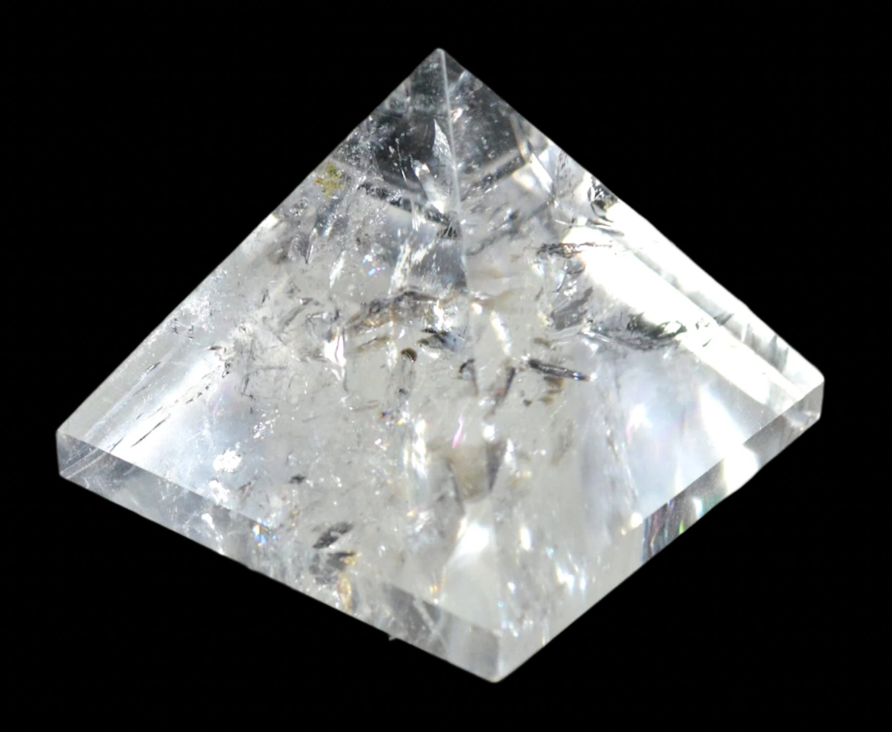Crystal quartz pyramid on a black background