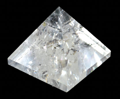 Crystal quartz pyramid on a black background