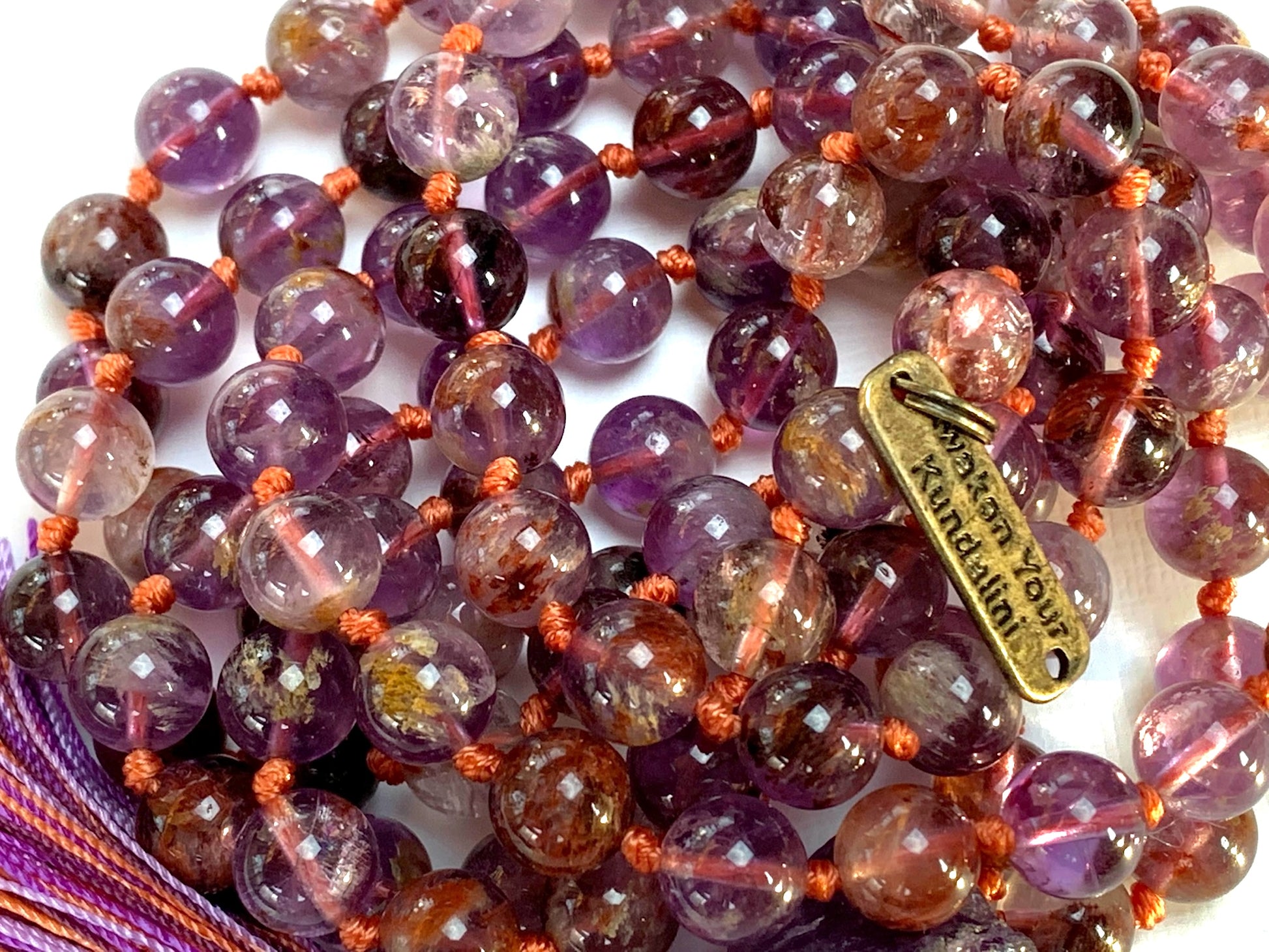 Detail shot of Cacoxenite Auralite beads and Amethyst stones in meditation mala by AYK