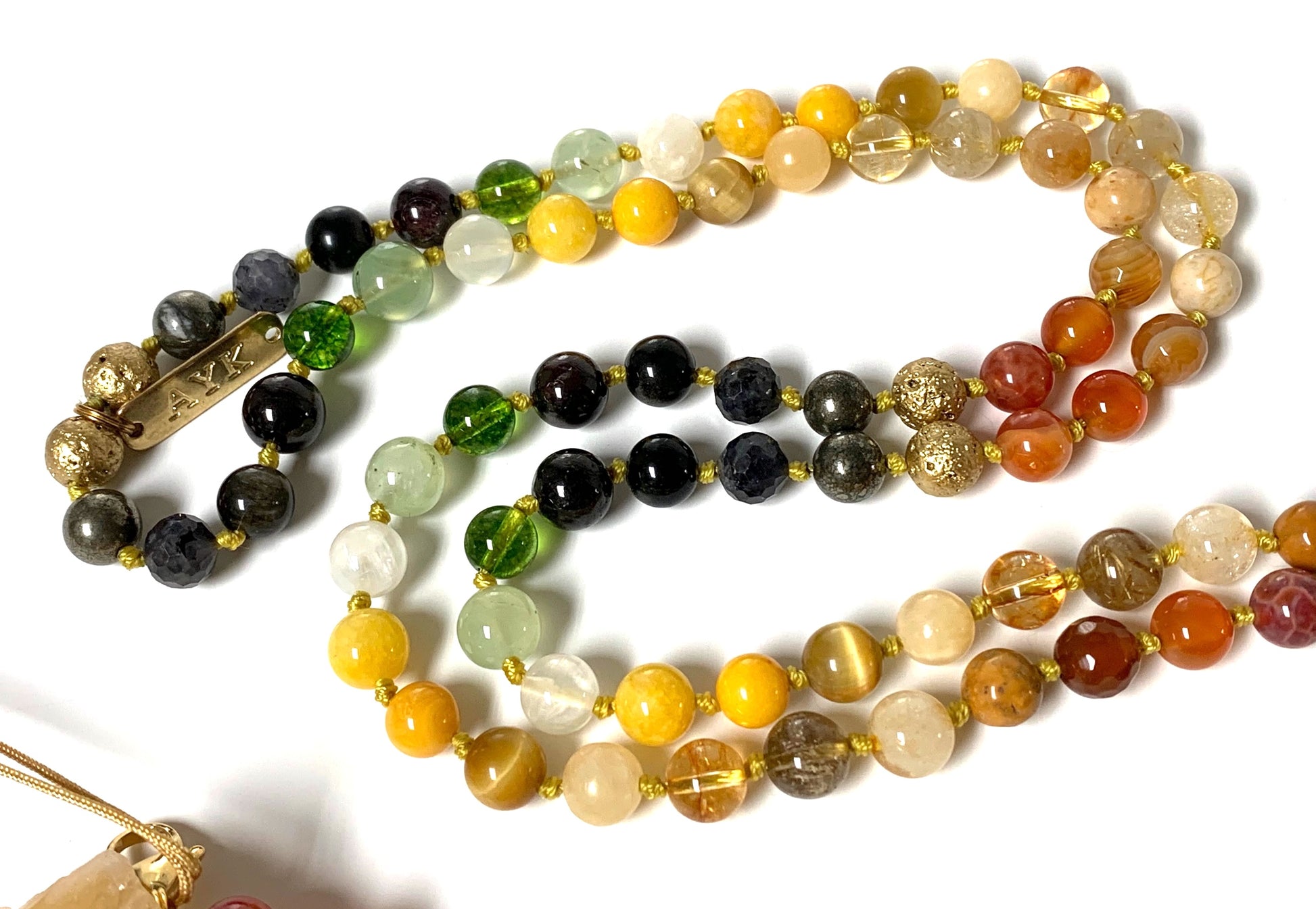 Detail shot of carnelian, pyrite and golden obsidian beads in Solar Alchemy Manifestation Mala