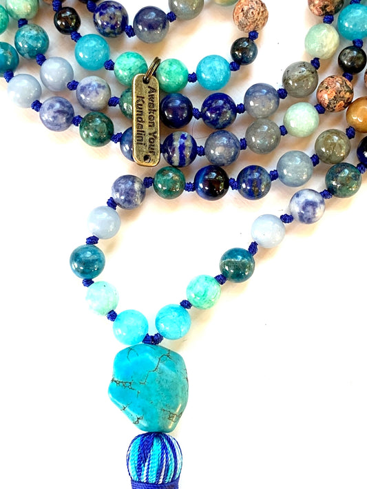Close-up view of Sacred Voice Mala beads showing aquamarine, turquoise, lapis lazuli and throat chakra stones
