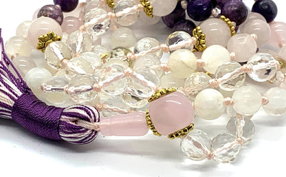 Close-up view of Lunar Love Mala beads showing charoite, rose quartz, moonstone and crystal quartz