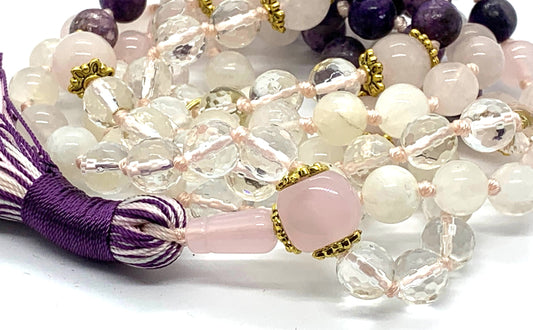 Close-up view of Lunar Love Mala beads showing charoite, rose quartz, moonstone and crystal quartz
