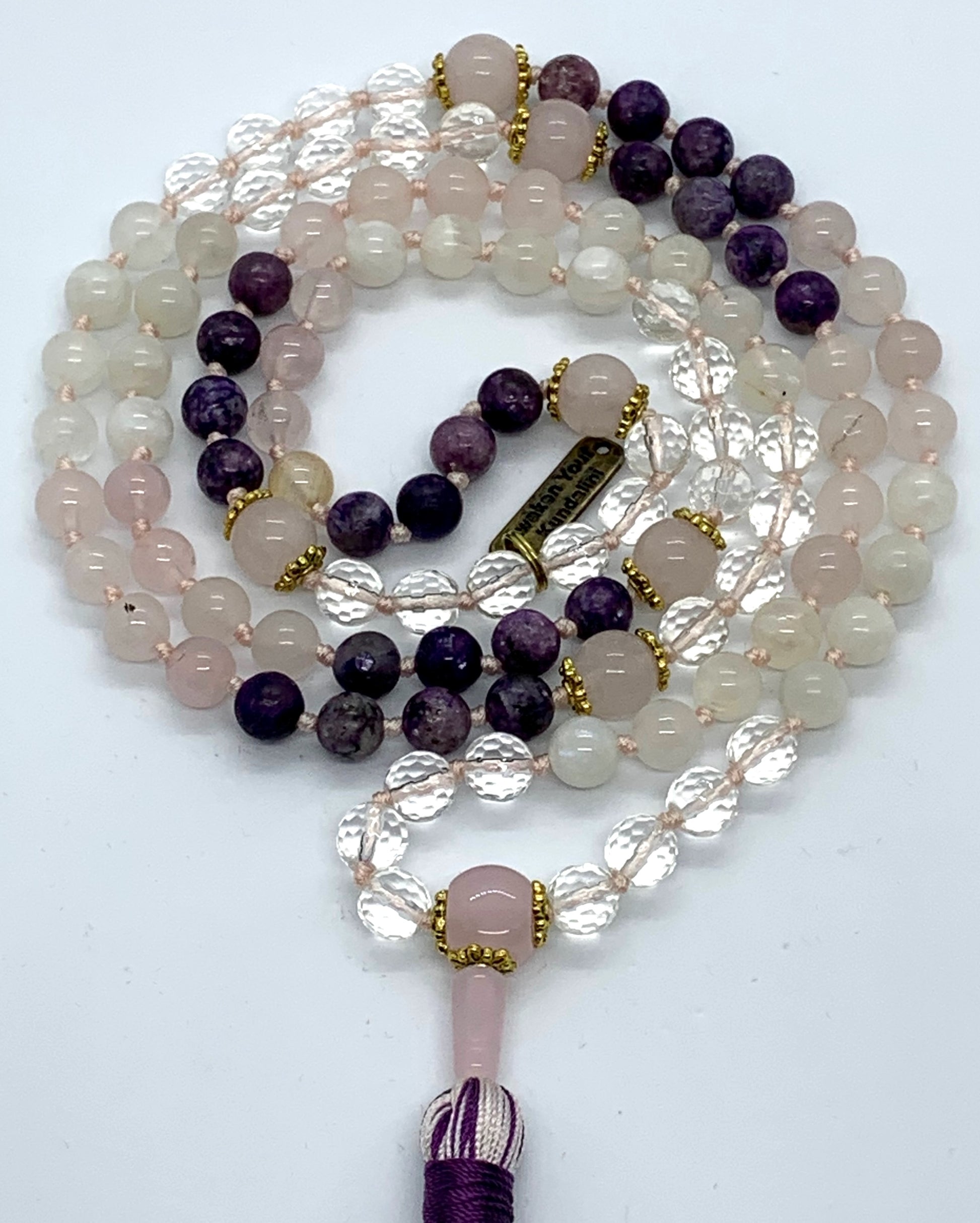 Detail shot of rose quartz and moonstone beads for heart chakra and intuitive healing