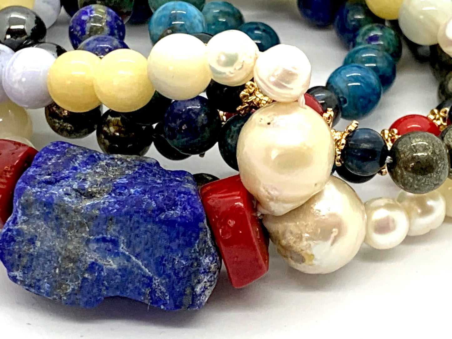 Detail shot of azurite, lapis lazuli, kyanite and calcite beads for throat and third eye chakras
