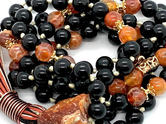 Close-up view of Inferno Guardian Mala beads showing black tourmaline, fire agate and carnelian gemstones