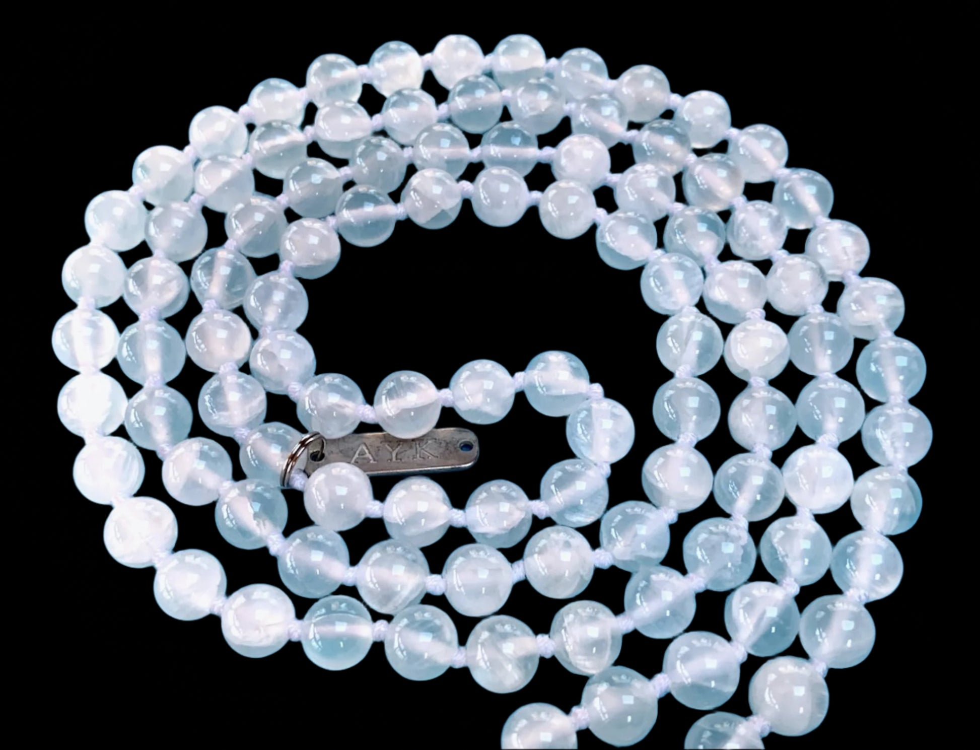 Hand knotted selentte mala necklace with 8mm bead size and 108 beads strung in white nylon thread and white tassel
