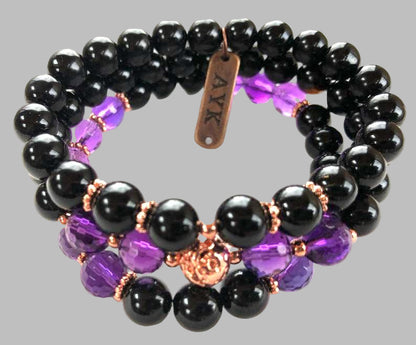 Black, purple, and rose gold beaded bracelet on a white background by AYK