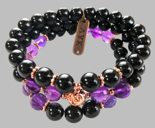 Black, purple, and rose gold beaded bracelet on a white background by AYK